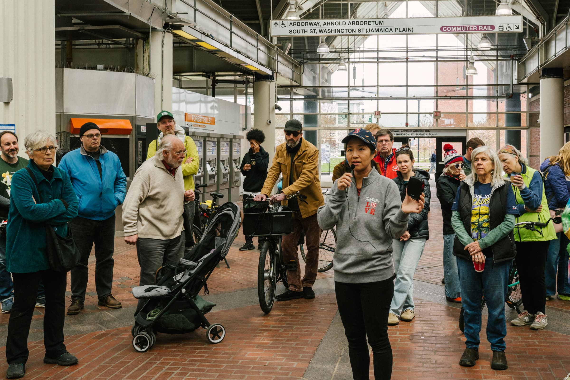 Mayor Michelle Wu speaking with residents at the Hyde Park Avenue safety walk inside Forest Hills station